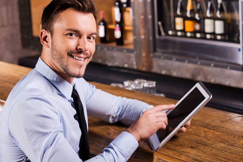 Restaurant Employee with iPad at Bar
