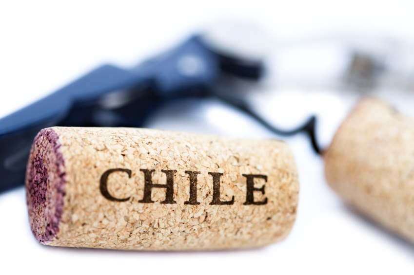 Two 'Chile' corks, one of them screwed to a blue bottle opener, the other one stained with red wine. Isolated on white background.